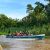 Tourists on a boat during a Kinabatangan River cruise, experiencing the core of a Borneo safari.