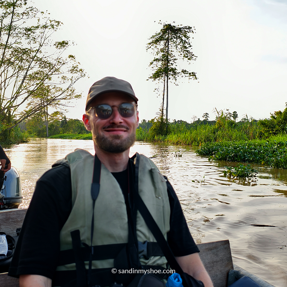 Petteri on a boat during a Kinabatangan River cruise, experiencing a Borneo safari.