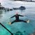 Petteri joyfully jumping into the crystal-clear waters of Mabul Island, a must-do adventure for a 10-day Malaysia itinerary