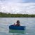 Young Sea Gypsy Malaysia girl floating on a handmade boat near her village