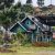 Traditional blue wooden house surrounded by greenery in Kundasang