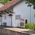 Ella train station sign mounted on the exterior wall of a local house, highlighting the town’s name in Sinhala, Tamil, and English—an iconic sight for travelers exploring things to do in Ella.