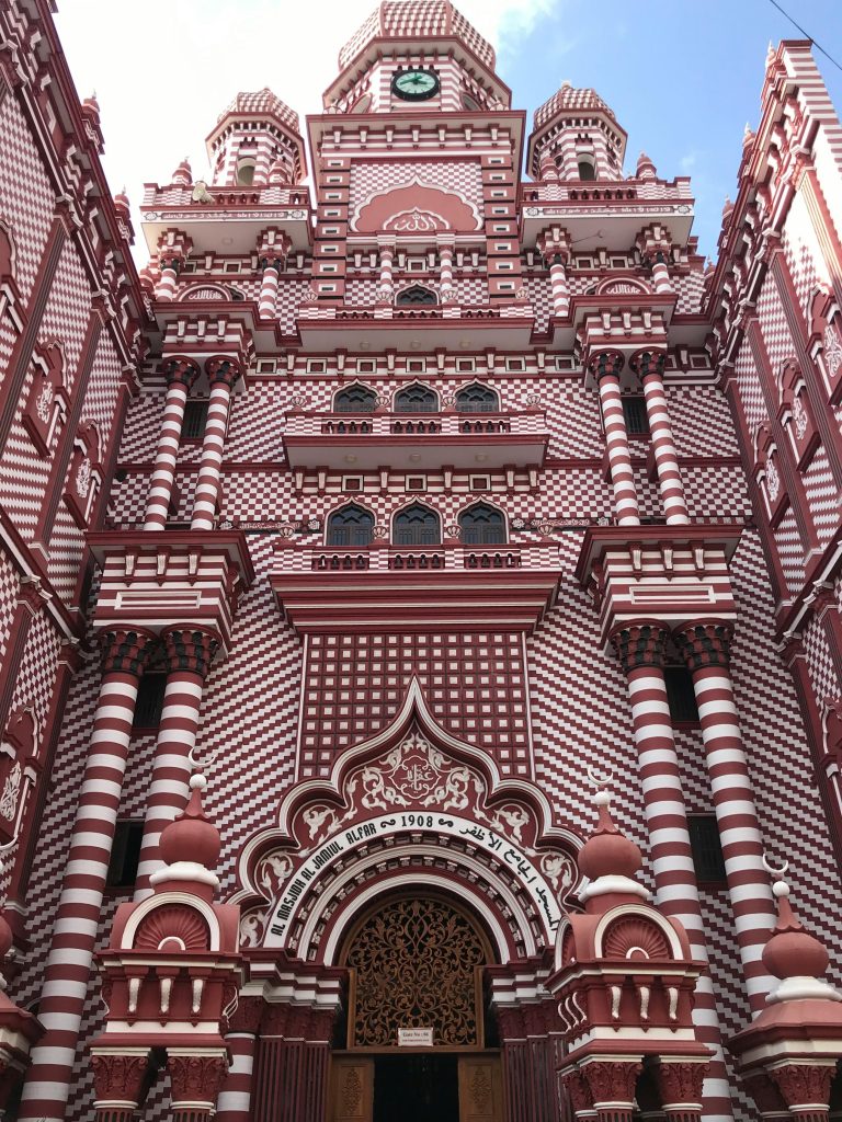 The striking red mosque in Pettah area — one of many stops in the Colombo one day itinerary.