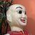 Wooden sculpture of a funny‑looking man seen during a Ho Chi Minh City itinerary.